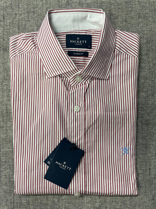 Folded Hackett shirt with a tag on a gray textured background