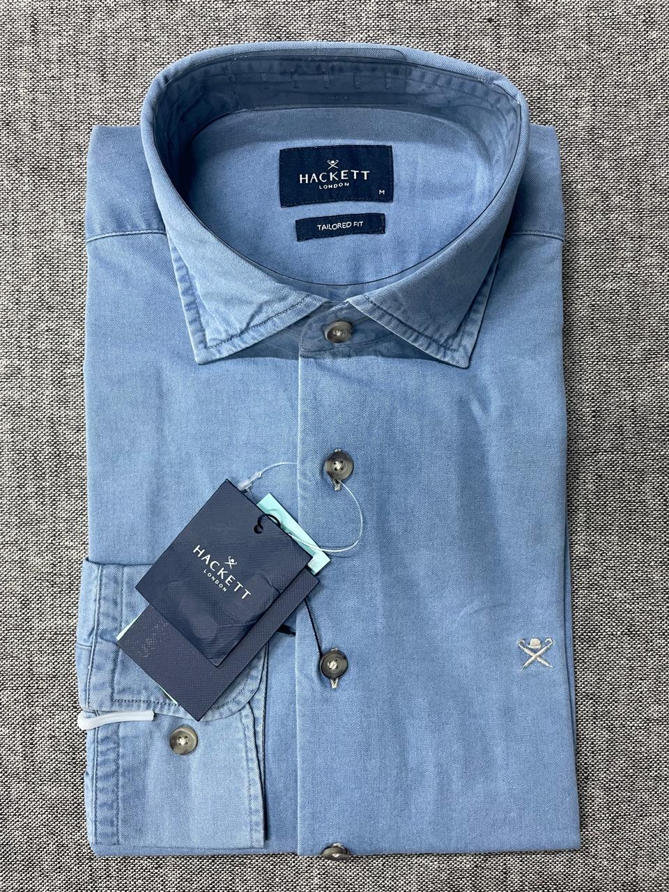 Light blue shirt with Hackett label on a textured gray background